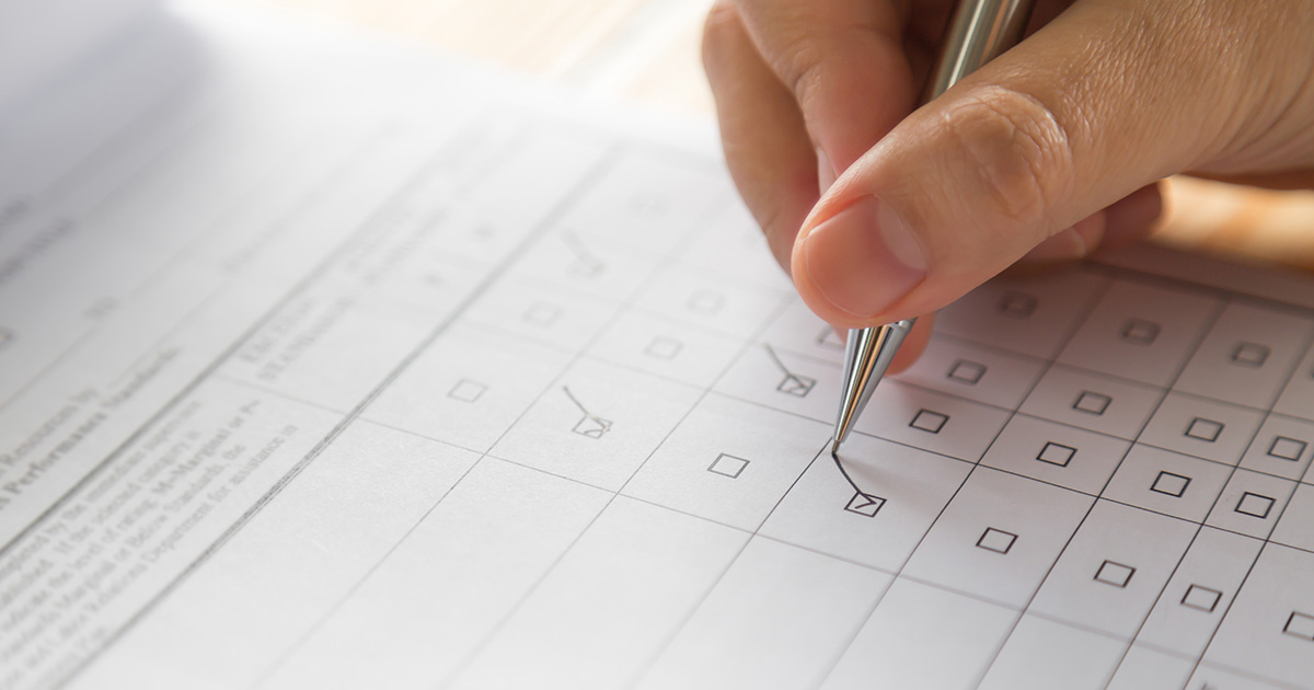 Hand with pen over application form